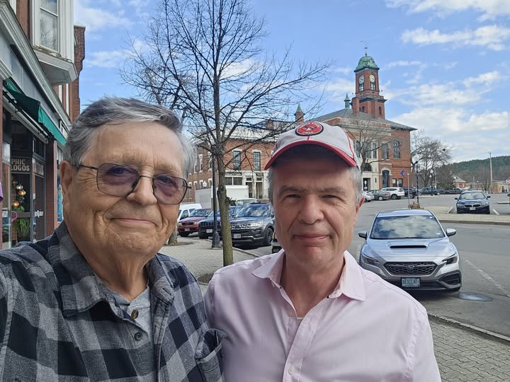 John Cloutier in downtown Claremont with the historic City Hall clock tower behind him